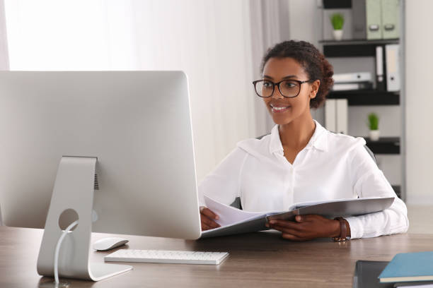 istock African American intern with folder working at table in office 1820832696