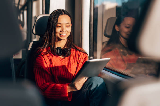 istock Happy Asian woman sitting in a fast train 1820844312