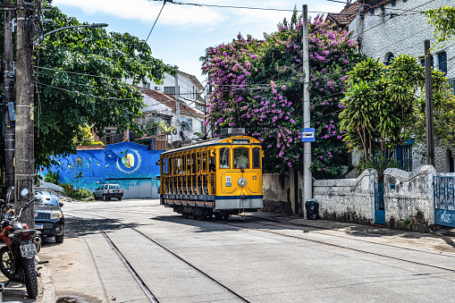 Rio de Janeiro, Brazil - Nov 29, 2023: The famous old tram Bonde de Santa Teresa in Rio de Janeiro, Brazil. Yellow tram traveling through the streets of the Santa Teresa district of Rio de Janeiro