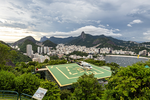 Rio de Janeiro, Brazil - Nov 29, 2023: Heliport with helicopter tour in pao de acucar, Rio de Janeiro in Brazil. Christ the Redeemer at the background