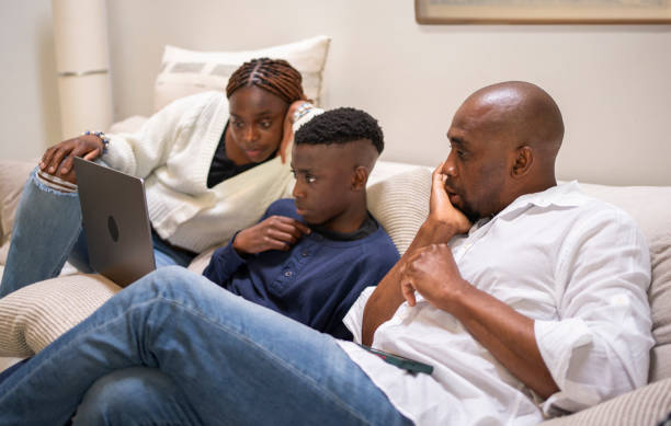 Free Stock Photo of Three People Sitting on a Couch Looking at a Laptop ...