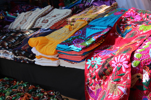 A pile of colorful Andes textiles on the sunday art and craft market of Otavalo in Ecuador, north of Quito.
