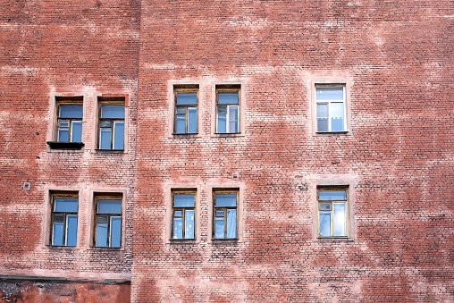 Pink brick building wall with windows, full frame