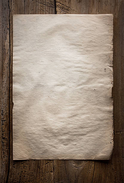 istock paper on wooden background 182088892