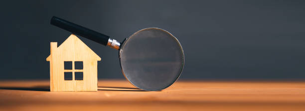 istock Wooden house and magnifying glass 1820889932