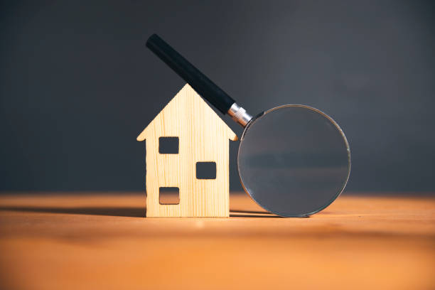 istock Wooden house and magnifying glass 1820889940