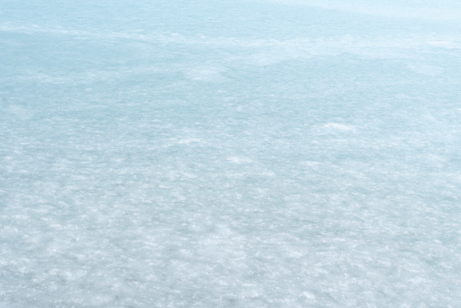 Frozen water in the lake, ice surface on the water.