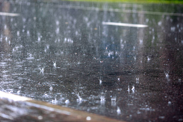 istock drops of rain fall in a puddle 182089424
