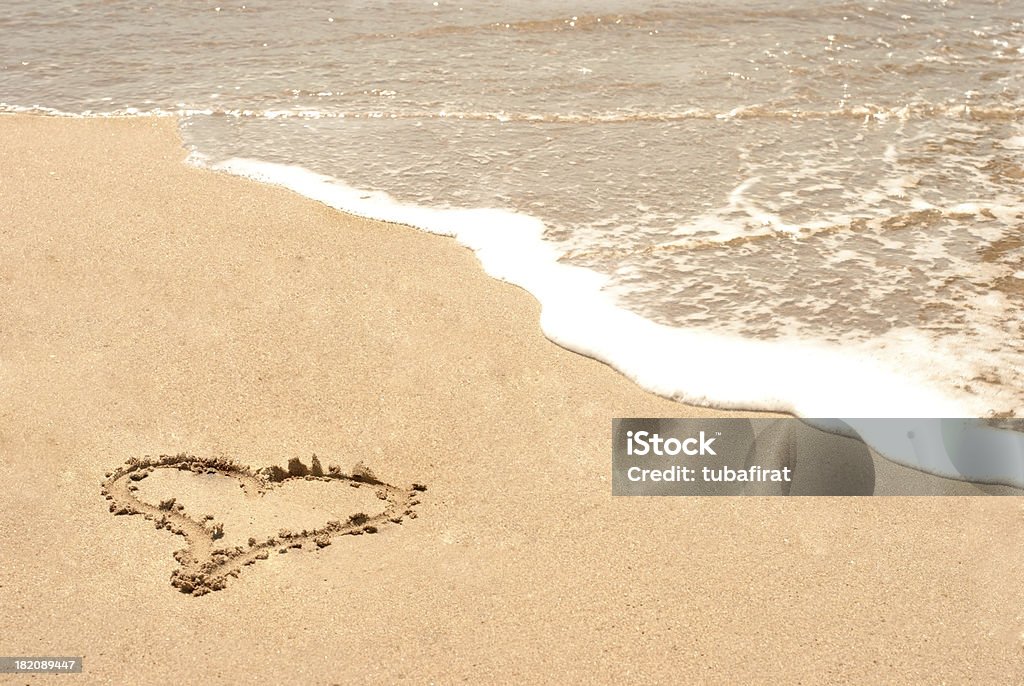 Love sign on the beach Heart shape on the sand. Beach Stock Photo