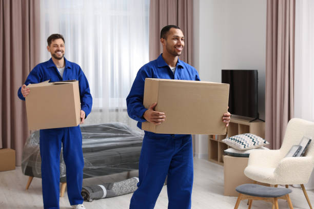 istock Male movers with cardboard boxes in new house 1820896448