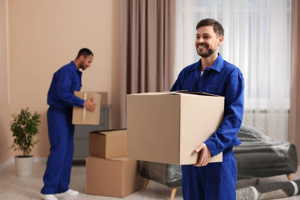 istock Male movers with cardboard boxes in new house 1820898746