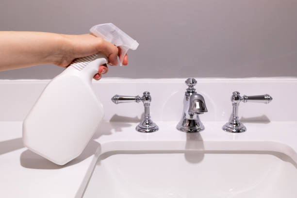istock White Blank Plastic Spray Bottle In Female Hands On White Sink In Bathroom. Packaging Mockup. Blank Spray Bottle for Cleaning, Sanitary. Lifestyle. Empty Place For Text Or Logo Horizontal Plane. 1820909144