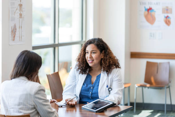 istock Female doctor gestures while discussing x-ray with female patient 1820934343