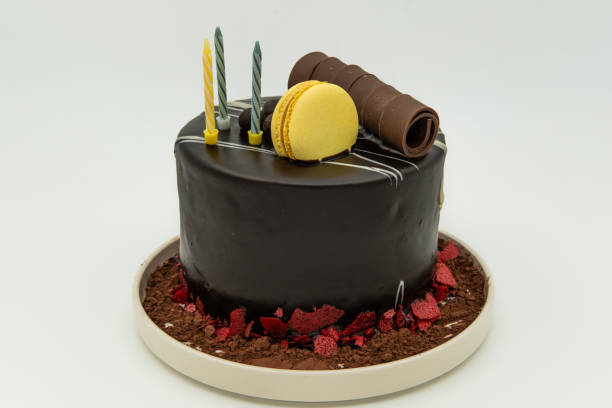 istock Chocolate cake with 3 candles on a white background 1820956093