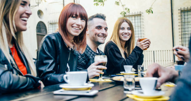 istock People tasting hot drinks at coffee restaurant - Millennial friends talking and having fun together at sidewalk cafe - Life style concept with happy men and women at bar cafeteria 1820963089