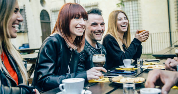 istock People tasting hot drinks at coffee restaurant - Millennial friends talking and having fun together at sidewalk cafe - Life style concept with happy men and women at bar cafeteria 1820964144