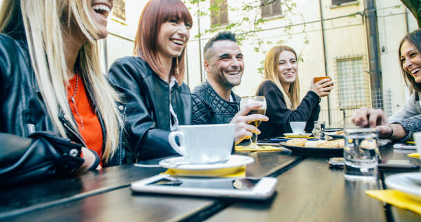 istock People tasting hot drinks at coffee restaurant - Millennial friends talking and having fun together at sidewalk cafe - Life style concept with happy men and women at bar cafeteria 1820964156