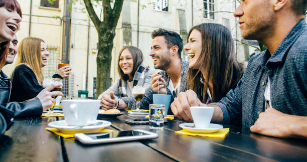 istock People tasting hot drinks at coffee restaurant - Millennial friends talking and having fun together at sidewalk cafe - Life style concept with happy men and women at bar cafeteria 1820964661