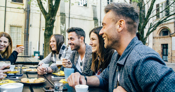 istock People tasting hot drinks at coffee restaurant - Millennial friends talking and having fun together at sidewalk cafe - Life style concept with happy men and women at bar cafeteria 1820964674