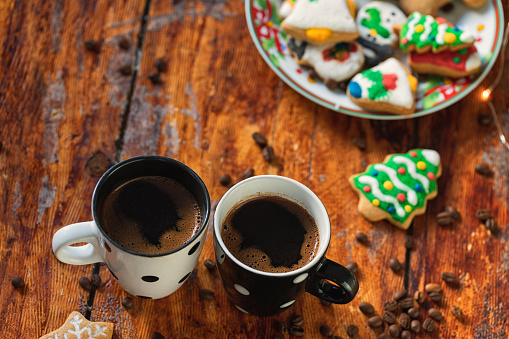 Two cups of hot coffee on the table in front of Christmas tree