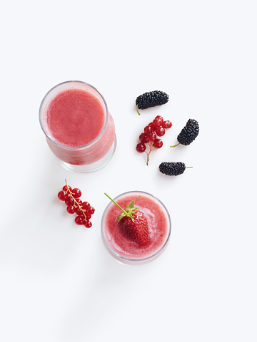 Berries with summer drink on a white background.