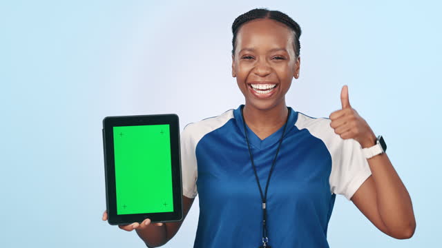 Sports woman, tablet and green screen with thumbs up for coach app against a studio background. Portrait of African person or athlete with technology display, like emoji or yes sign on mockup review