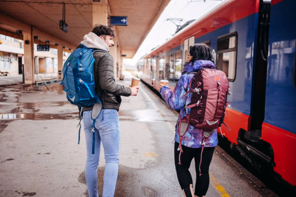 istock Young couple waiting for transport on train station 1821003004