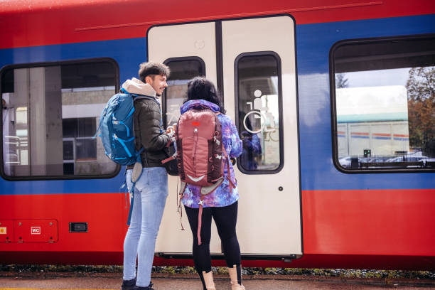 istock Young couple waiting for transport on train station 1821003108
