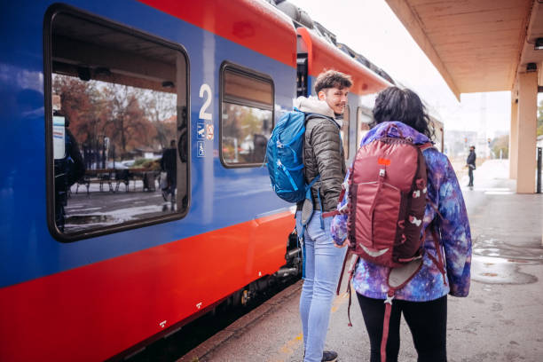 istock Young couple waiting for transport on train station 1821003649