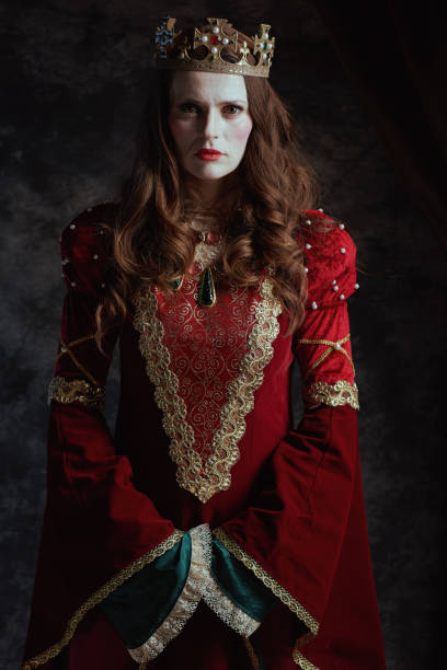 istock medieval queen in red dress with white makeup and crown 1821022591