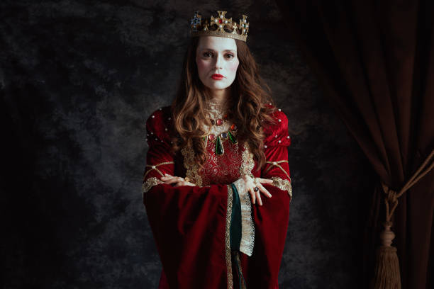 istock medieval queen in red dress with white makeup and crown 1821022592