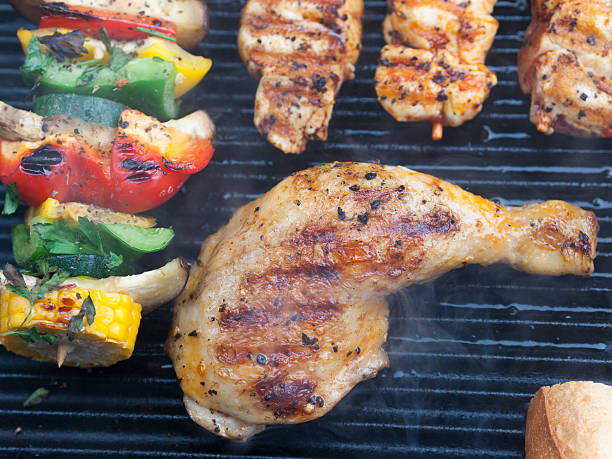 istock Delicious BBQ chicken, meat and vegetables on a barbecue 182102678