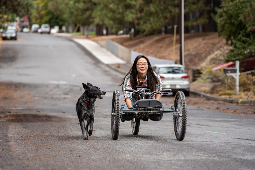 Asian woman using an adaptive mountain bike and enjoying time outdoors