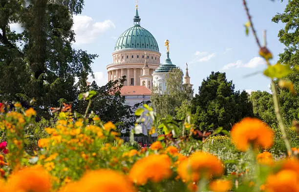 Dome and old town hall in Potsdam behind a flowered park