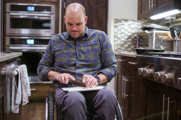 Man using a wheelchair and cooking at home
