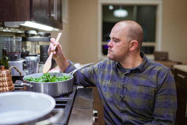 Man with a physical disability preparing meal at home