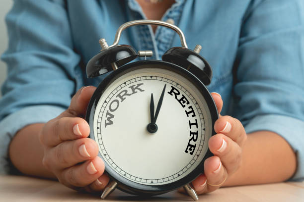istock Business woman holding black alarm clock with clockwise countdown from work to retirement 1821038076