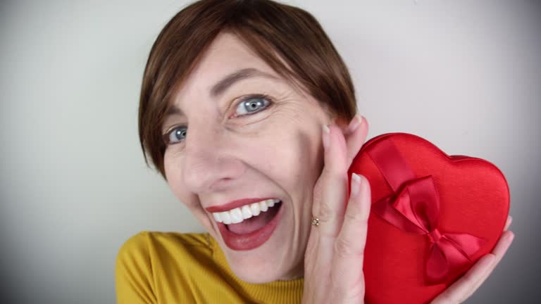 Happy Woman With Heart Shaped Box of Candy for Valentines Day