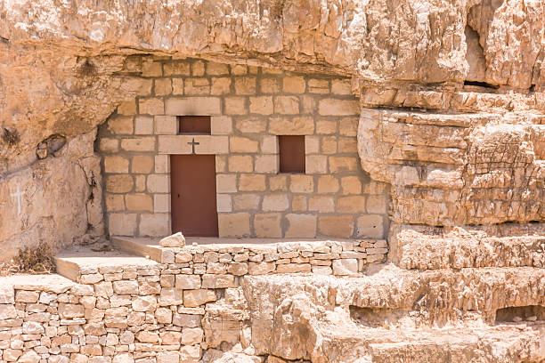 istock Monastic cave-cell in the mountain wall of Kidron river canyon 182105414