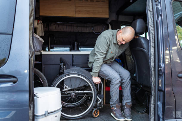istock Man who uses wheelchair getting in to camper van 1821056302