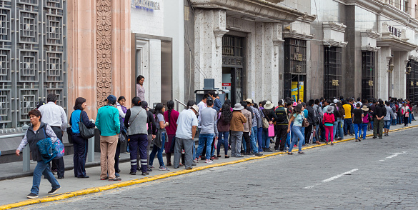 Arequipa, Peru, 07 10 2023 : huge queue of Bolivian people waiting to get into their bank.