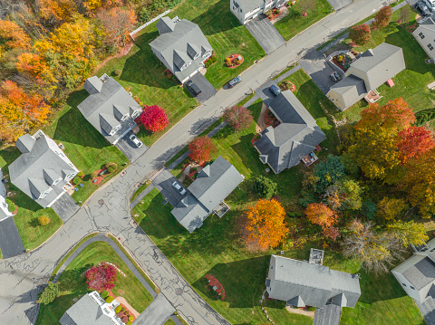 Aerial view of suburban housing community in autumn season with colorful trees