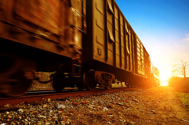 A freight train in motion on a sunny day Dusk, Motion Blur freight train. rail car stock pictures, royalty-free photos & images