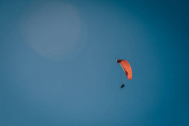 istock Paragliding soaring through the heights, you can see clouds and the blue sky 1821117605