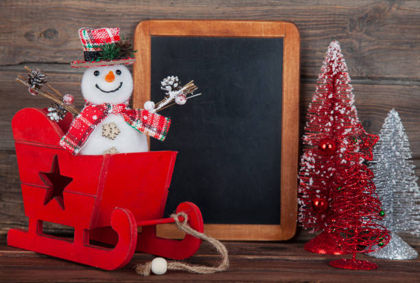 Blackboard with Christmas decoration on wood over rustic background with copy space for text