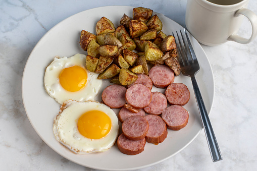fried eggs served with kielbasa with home fries
