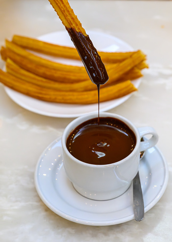 Churros con chocolate (churros with hot chocolate) is one of the most beloved treats in Madrid