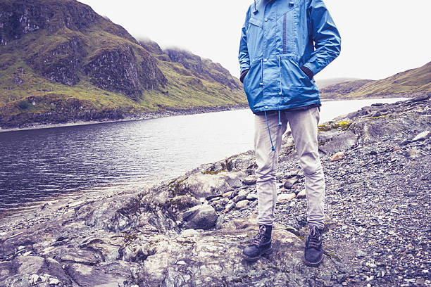 istock Hill walker standing by mountain lake 182119345
