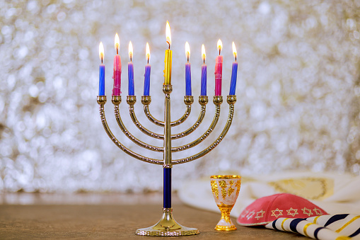 Hanukkiah Menorah candle light during traditional celebration of Jewish religion holiday