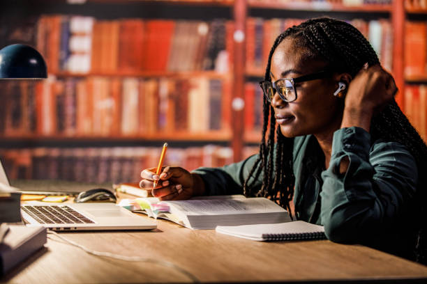 istock Contented female university student studying at the library 1821234266